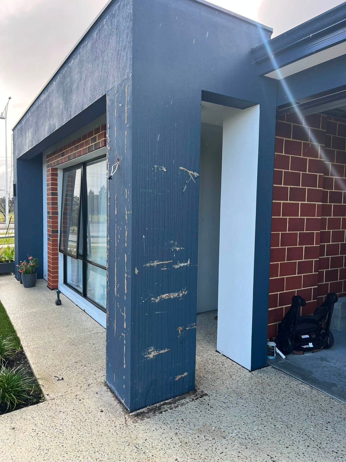 Before: the same entrance column with old, peeling paint